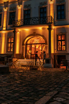 Elegant hospitality facility with warm lighting and inviting outdoor seating.