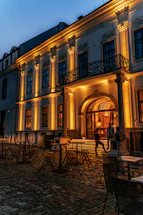 A warm, inviting view of the historic Coin Harvey House entrance bathed in soft evening light.