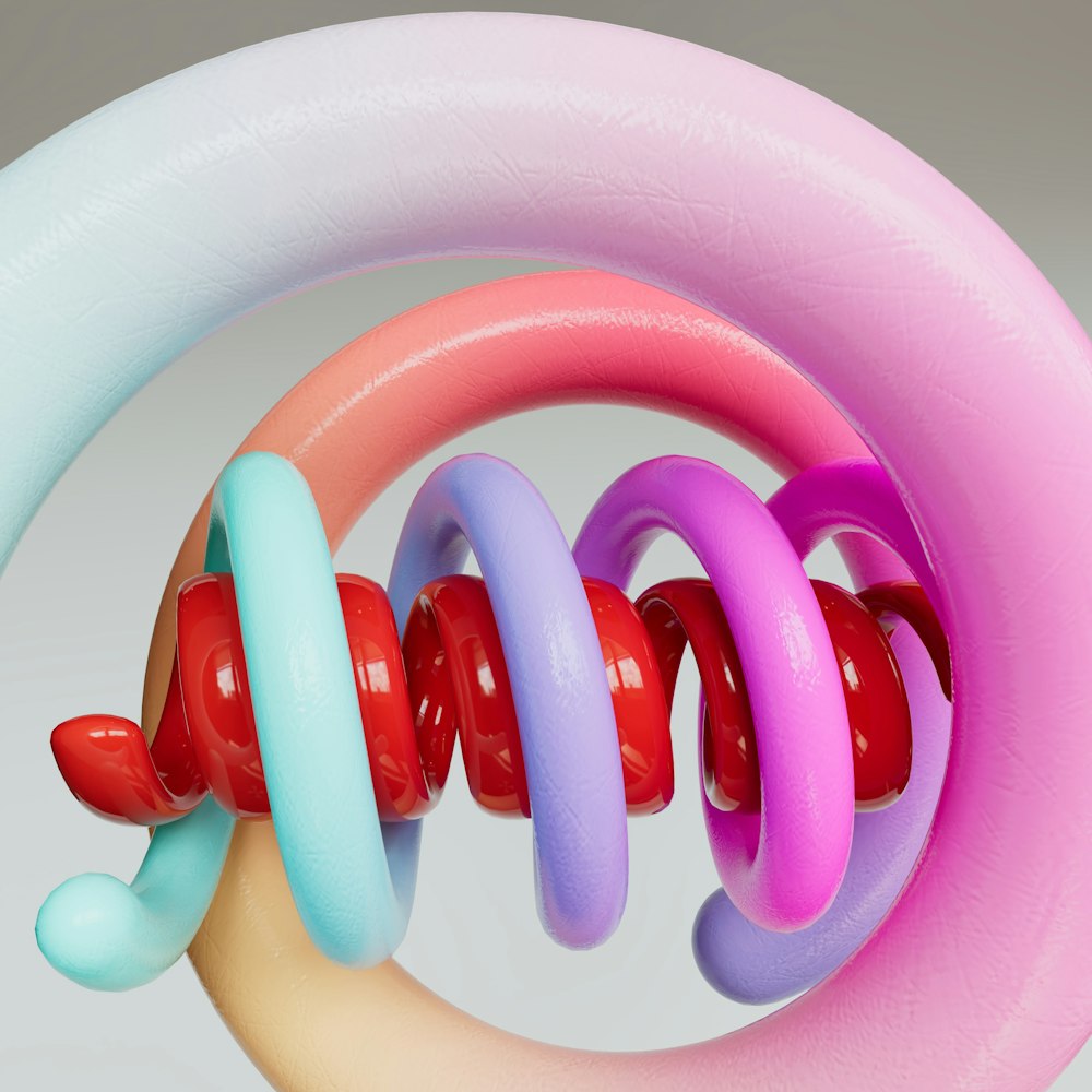 a hand holding a pink, blue, and red object