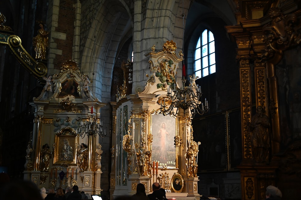 a church with a golden alter and a painting on the wall