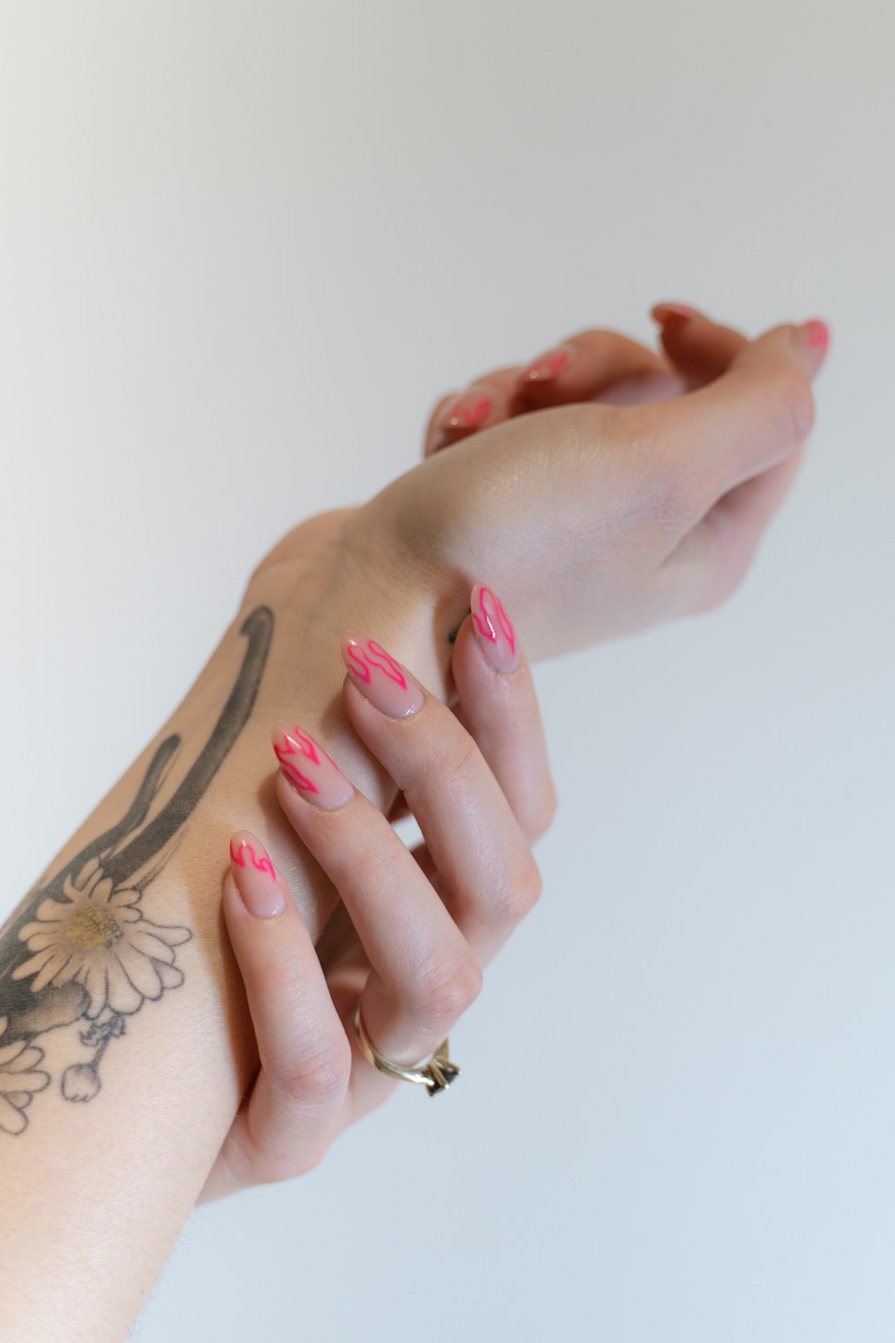 a woman's hand with pink and white nail polish