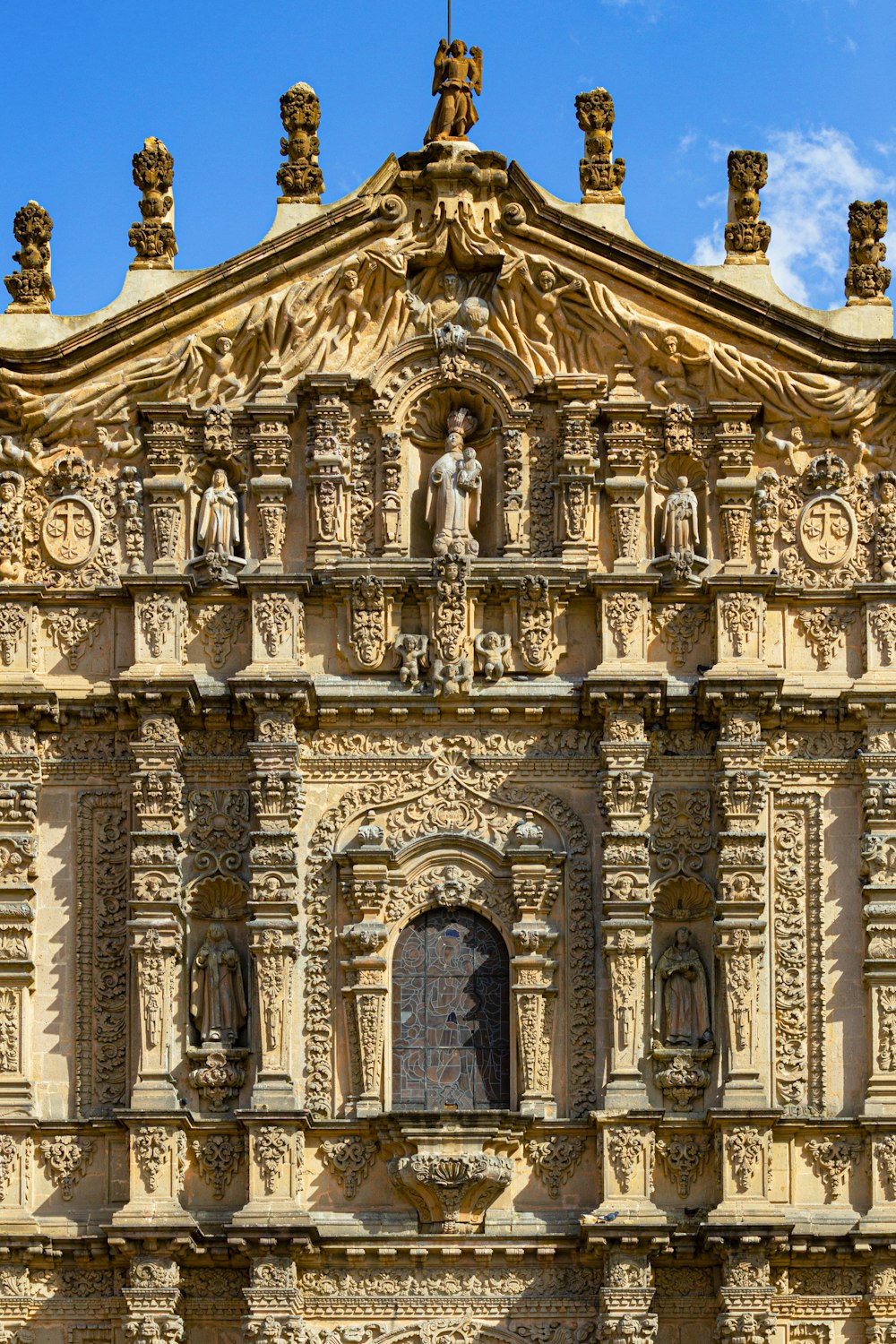 a large building with statues on the top of it