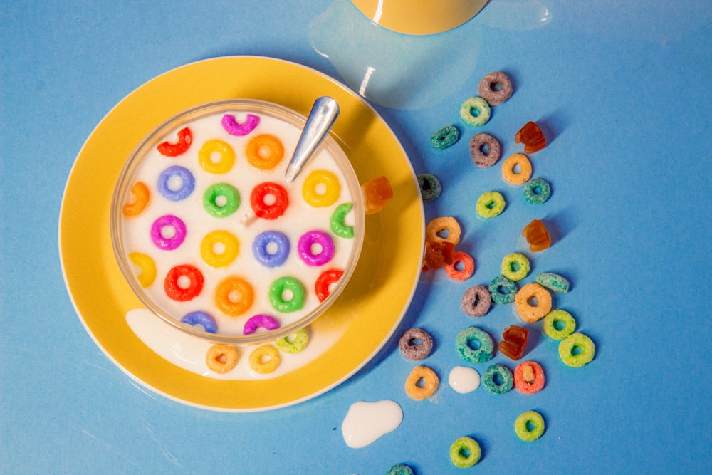 a bowl of cereal with a spoon on a plate