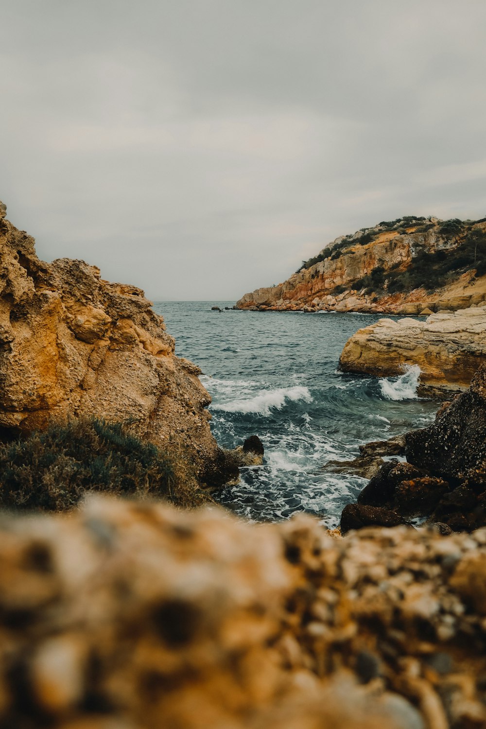 a view of the ocean from a rocky cliff