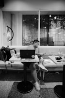 A person searching for acronyms on a smartphone in a modern café.
