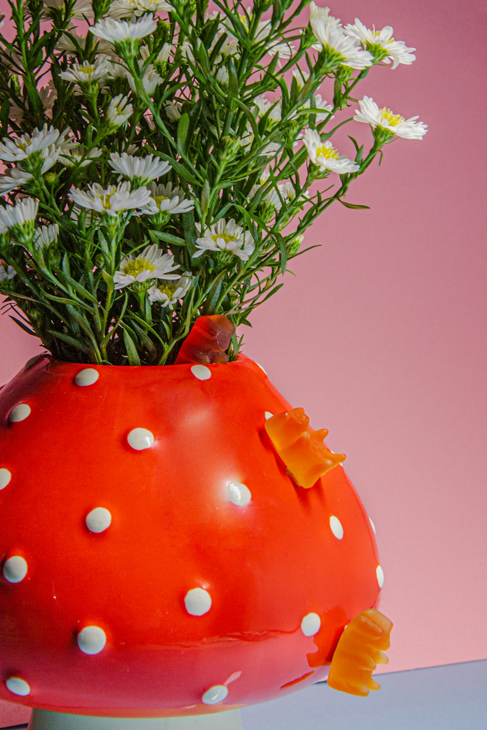 a vase filled with white flowers on top of a table