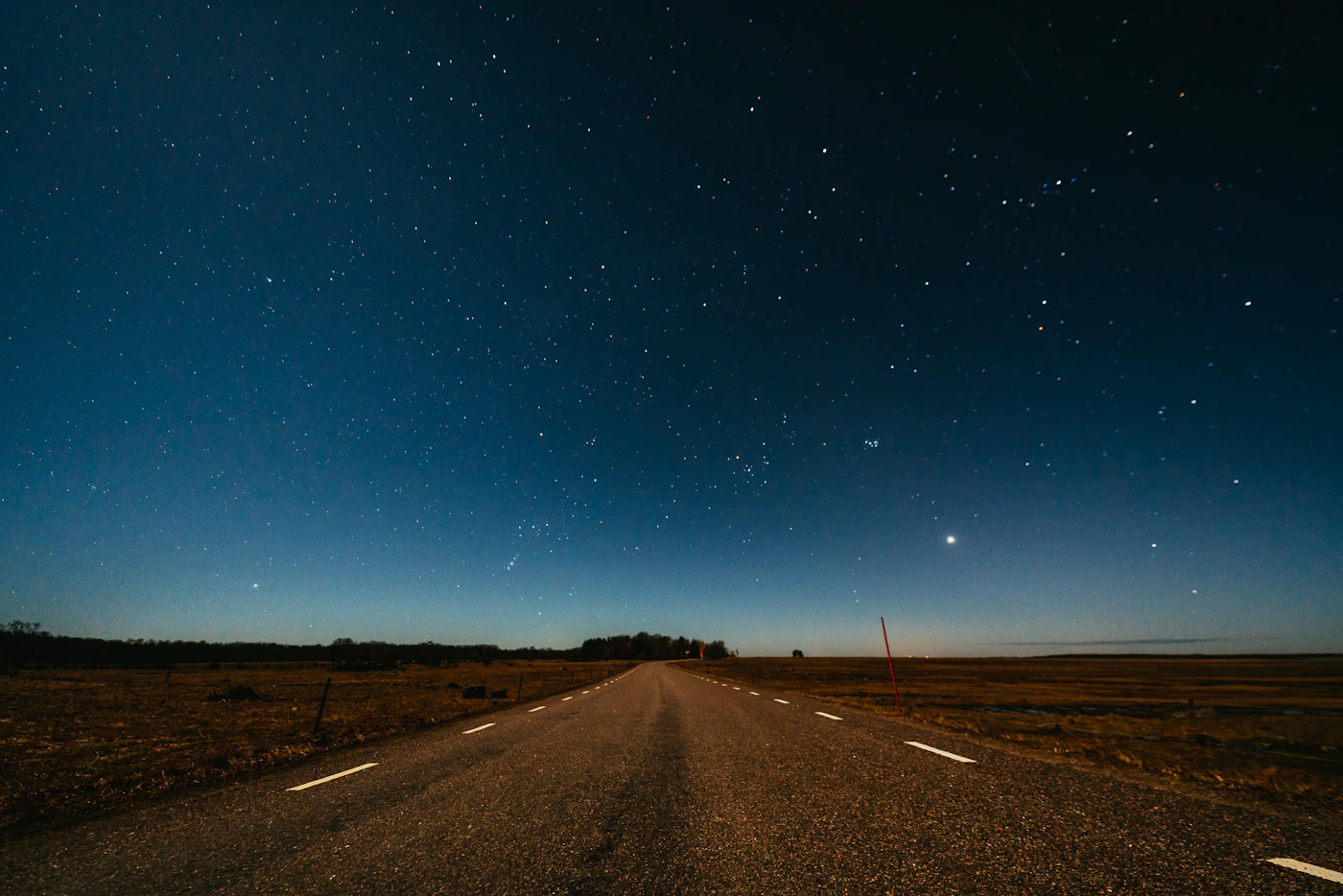 A highway stretching into the distance at dusk