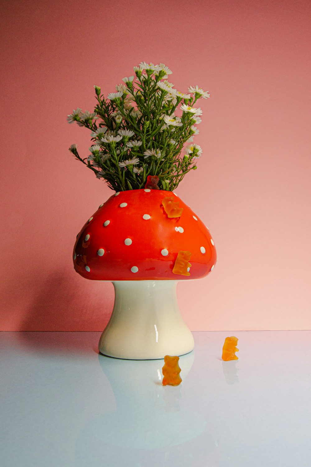 a mushroom shaped vase with flowers in it