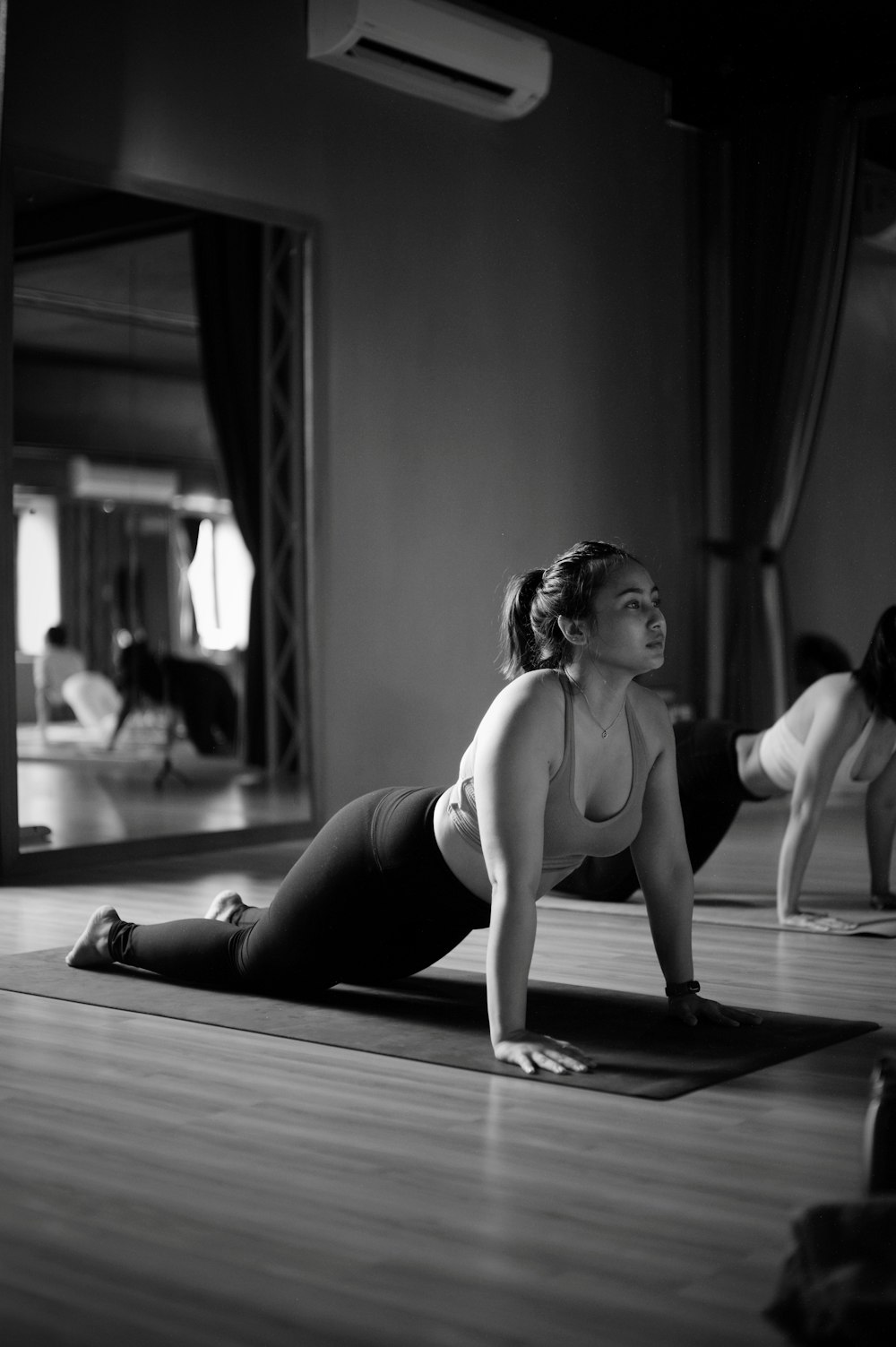 a woman is doing a yoga pose on a mat