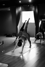 a group of people doing yoga in a room