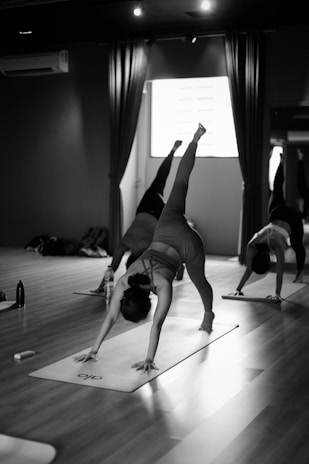 a group of people doing yoga in a room