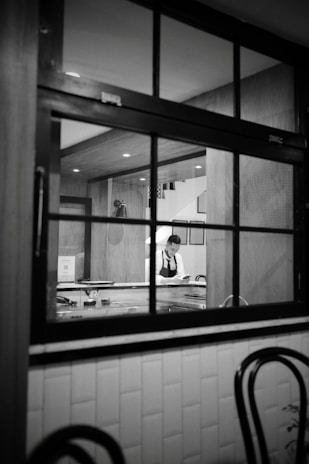 A high-quality photo of a professional maid cleaning a modern home.