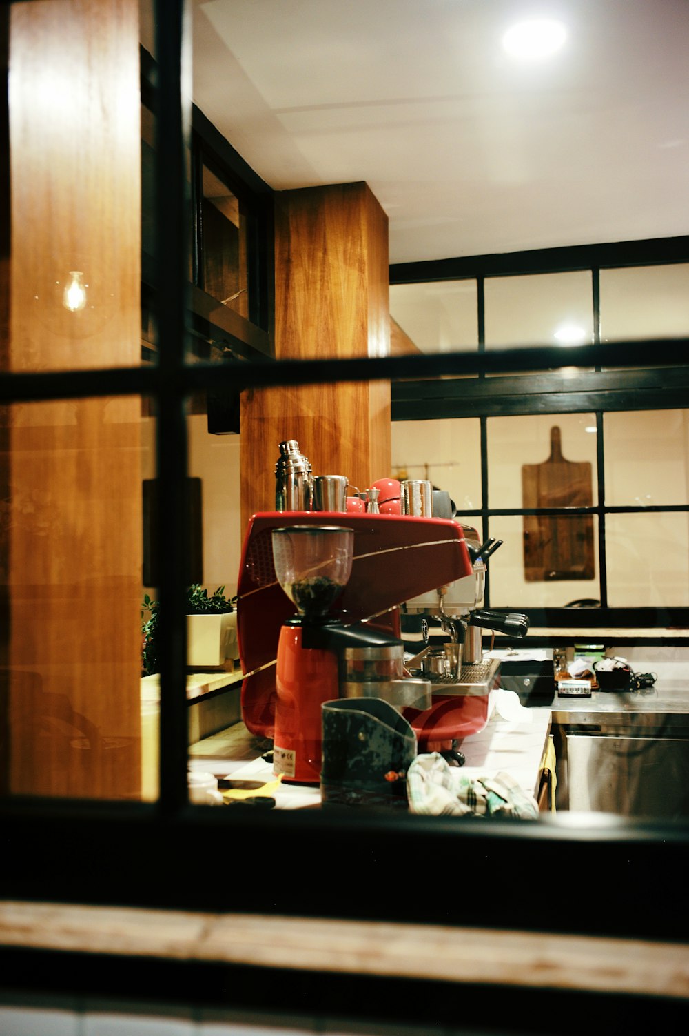 a kitchen filled with lots of clutter next to a window