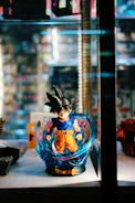 Intense battle moment featuring Goku in Ultra Instinct with energy radiating around him.