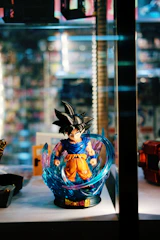 Goku in Ultra Instinct stance surrounded by radiant silver aura