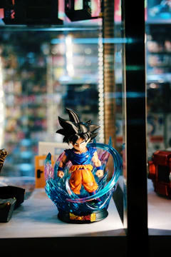Goku in Ultra Instinct stance surrounded by radiant silver aura