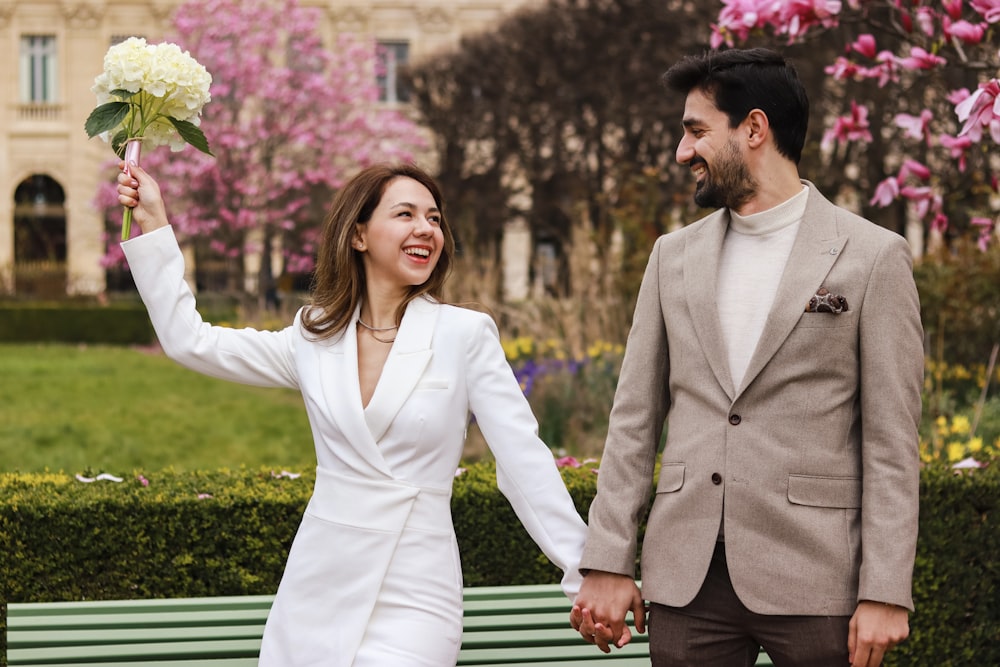 a man and a woman holding a bouquet of flowers