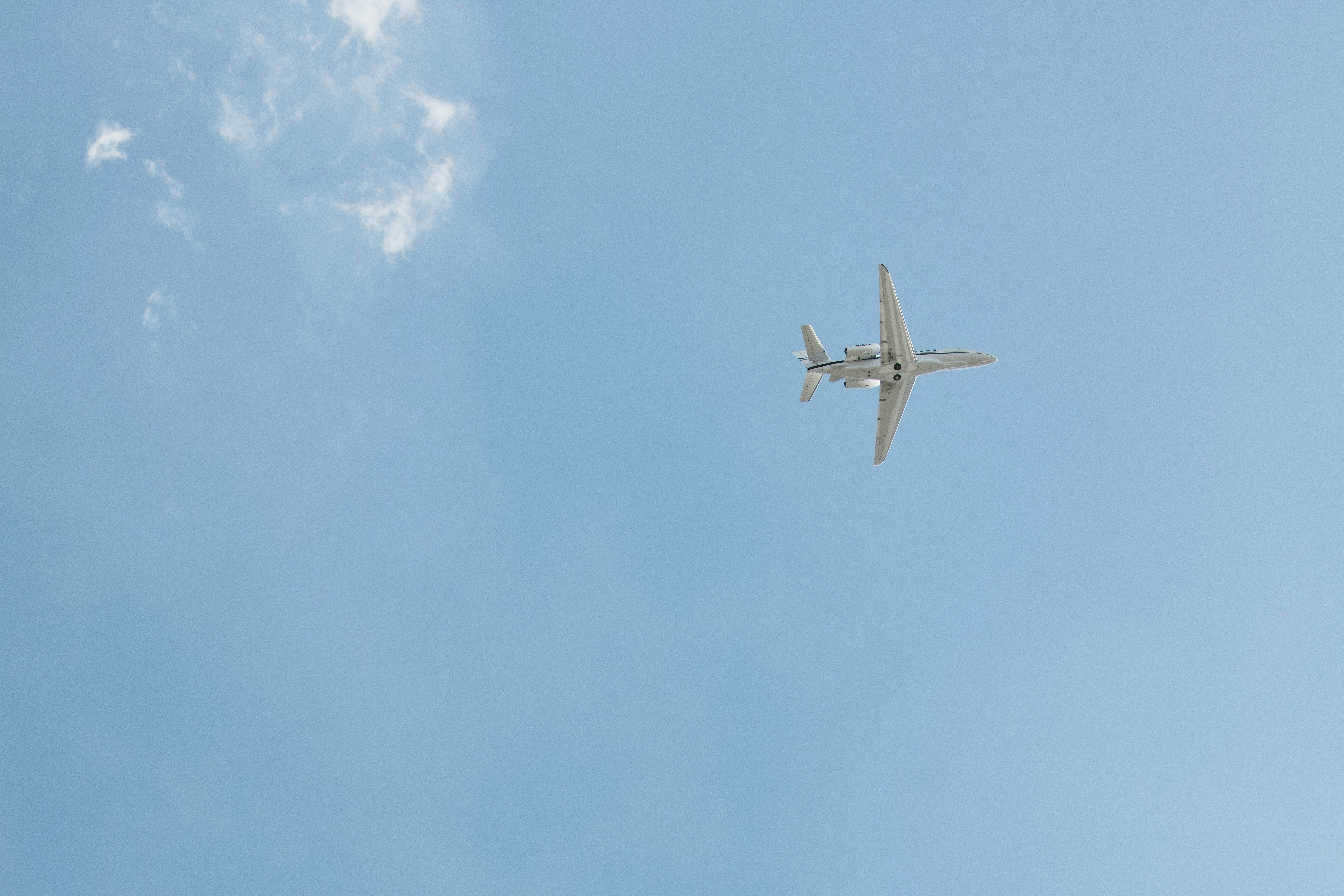 an airplane is flying in the blue sky