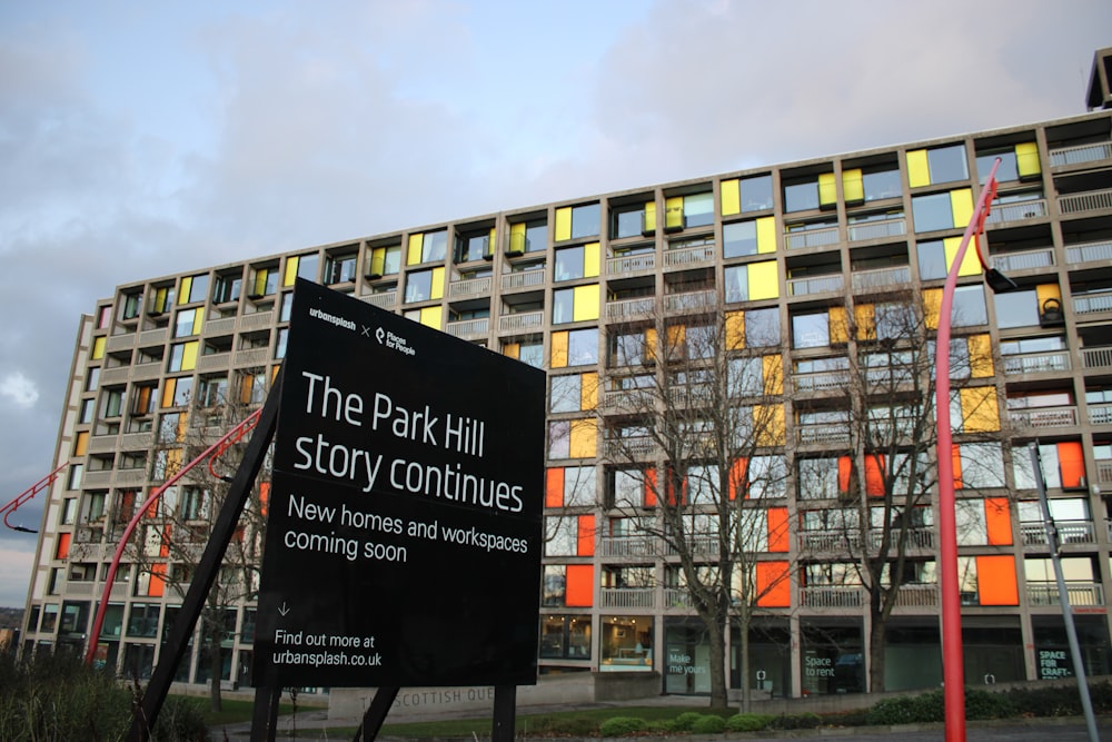 a sign in front of a building that says the park hill story continues