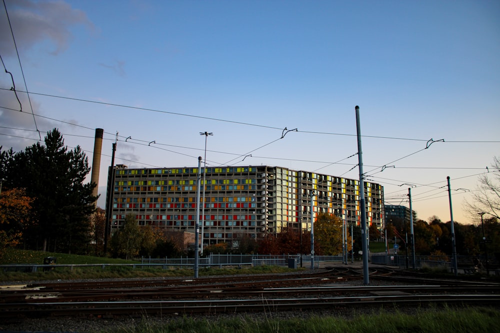 a tall building sitting on the side of a train track