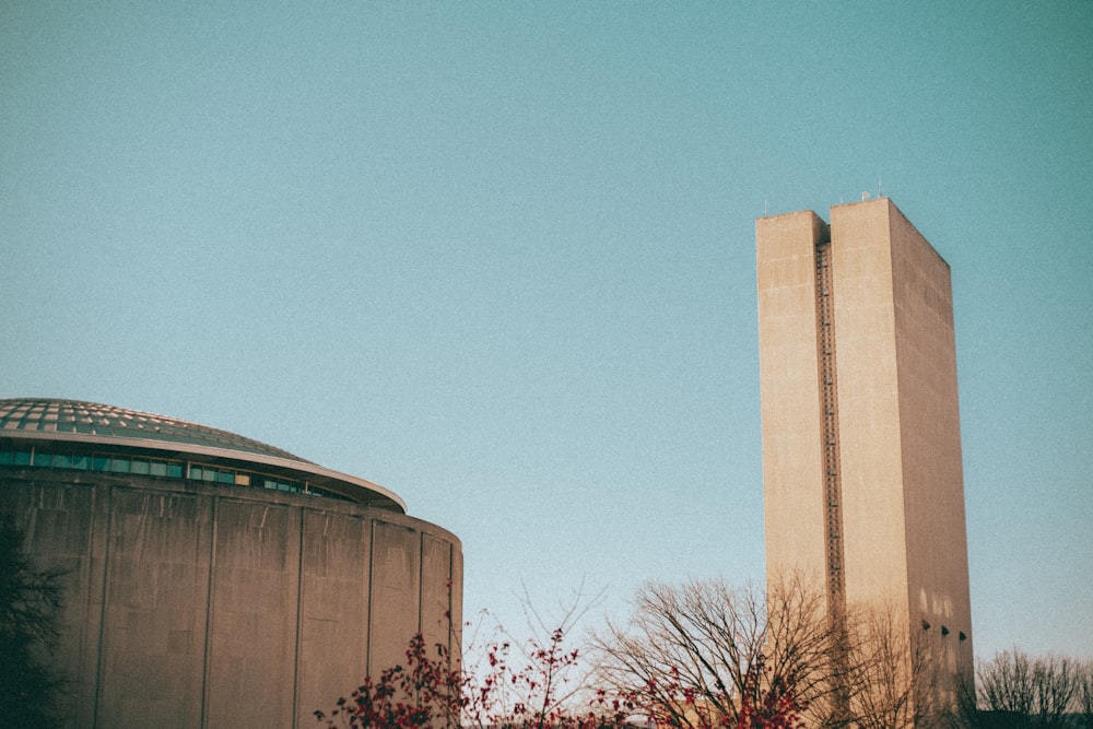 a tall building sitting next to a tall tower