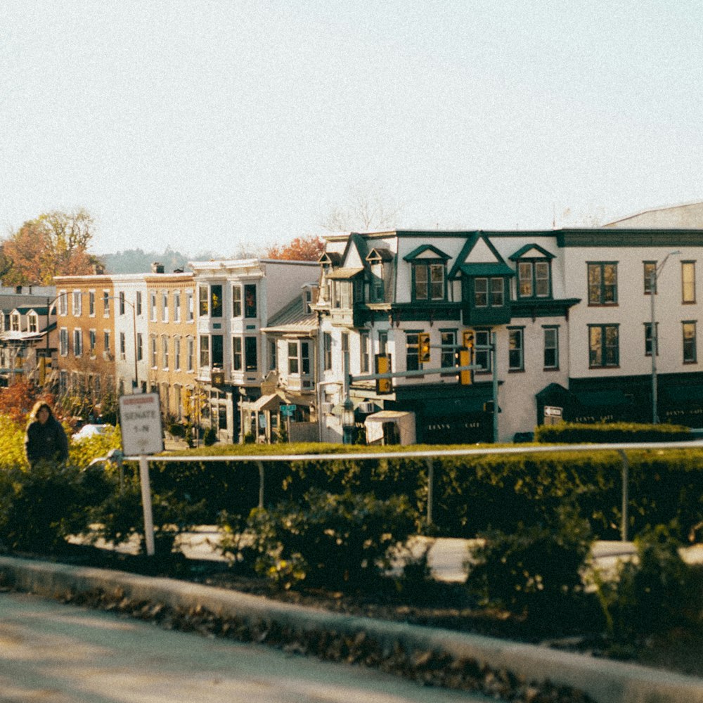 a view of a street with a bunch of houses in the background