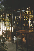 A cozy café terrace bathed in golden afternoon light, with delicate gold accents in the decor.