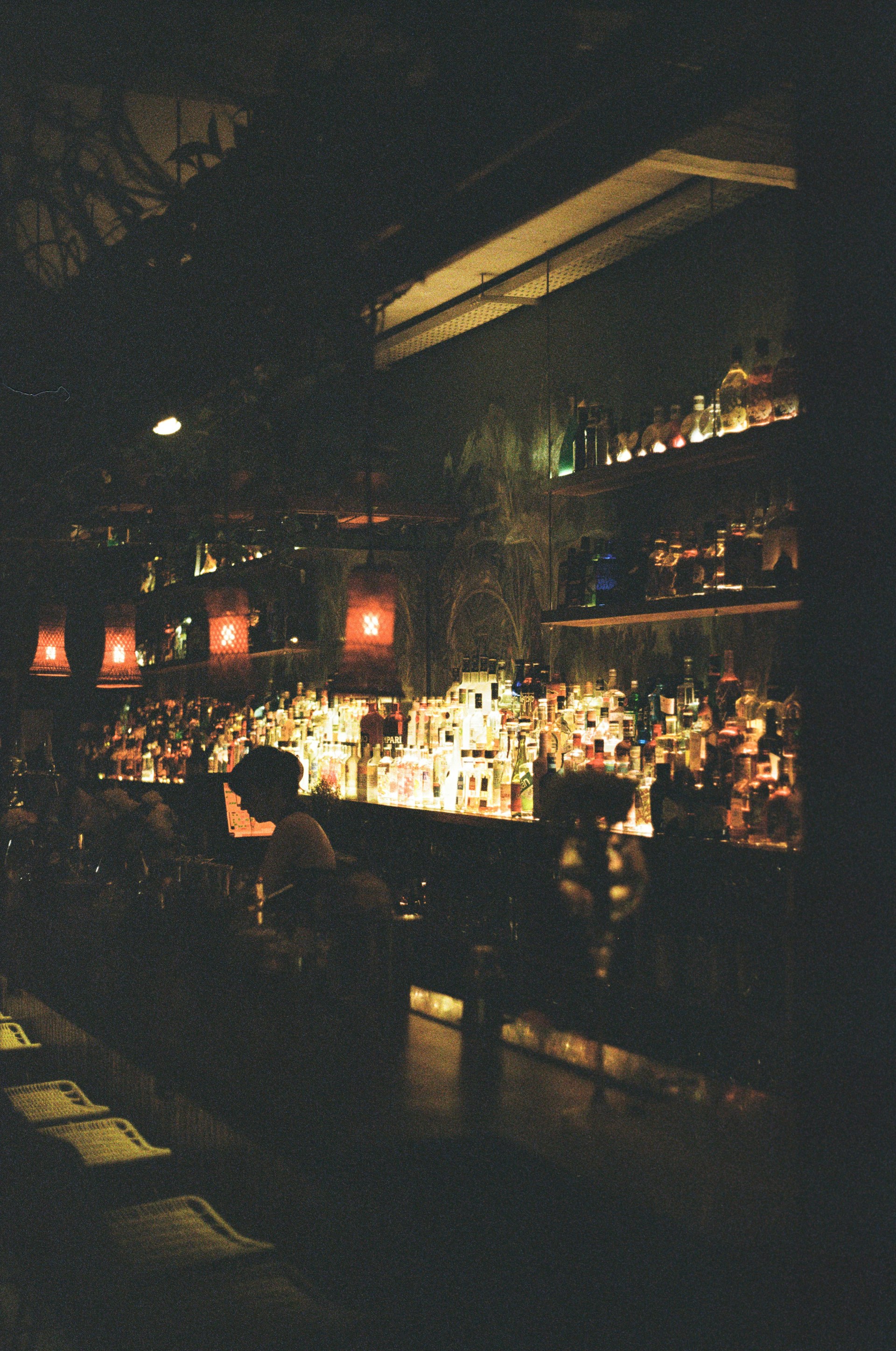 a bar filled with lots of bottles of liquor
