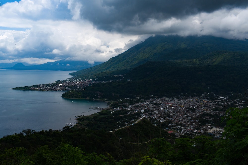 a large body of water surrounded by a lush green hillside