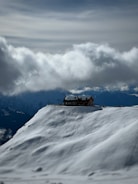 A dramatic stormy sky over a secluded mountain cabin.