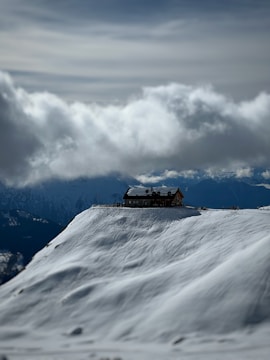 A dramatic stormy sky over a secluded mountain cabin.