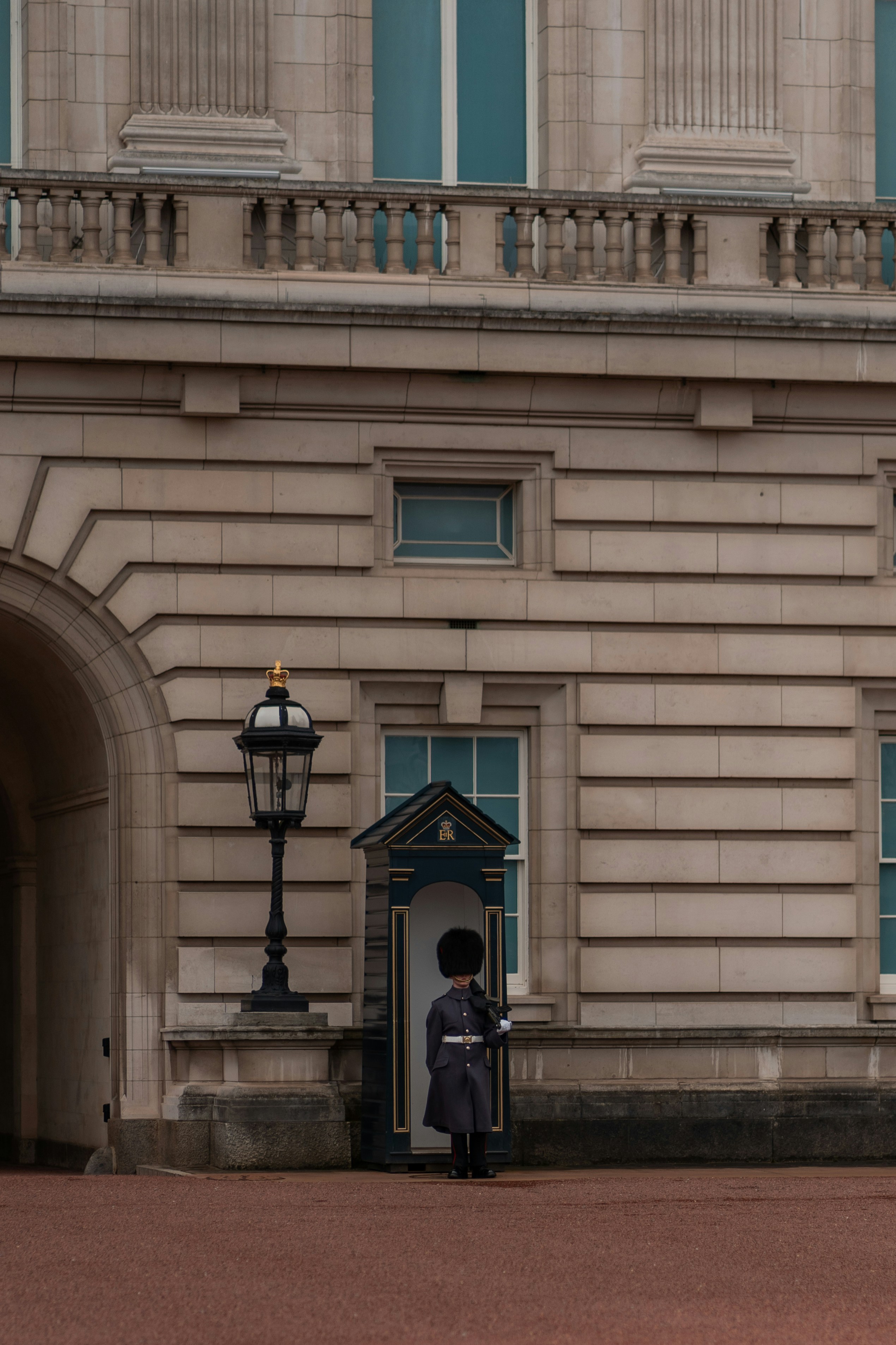 a man in uniform standing in front of a building