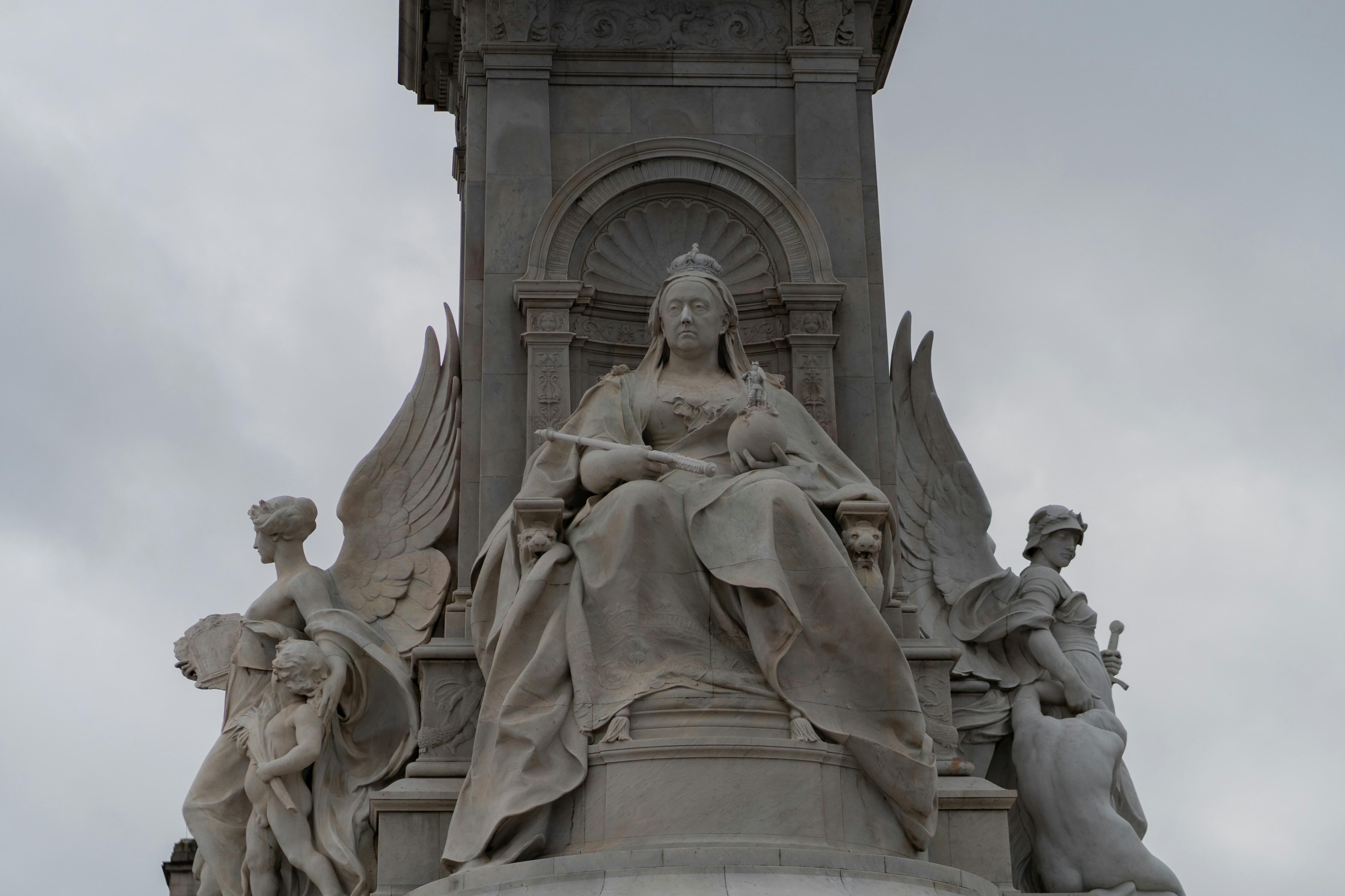 a statue of a woman sitting on top of a statue
