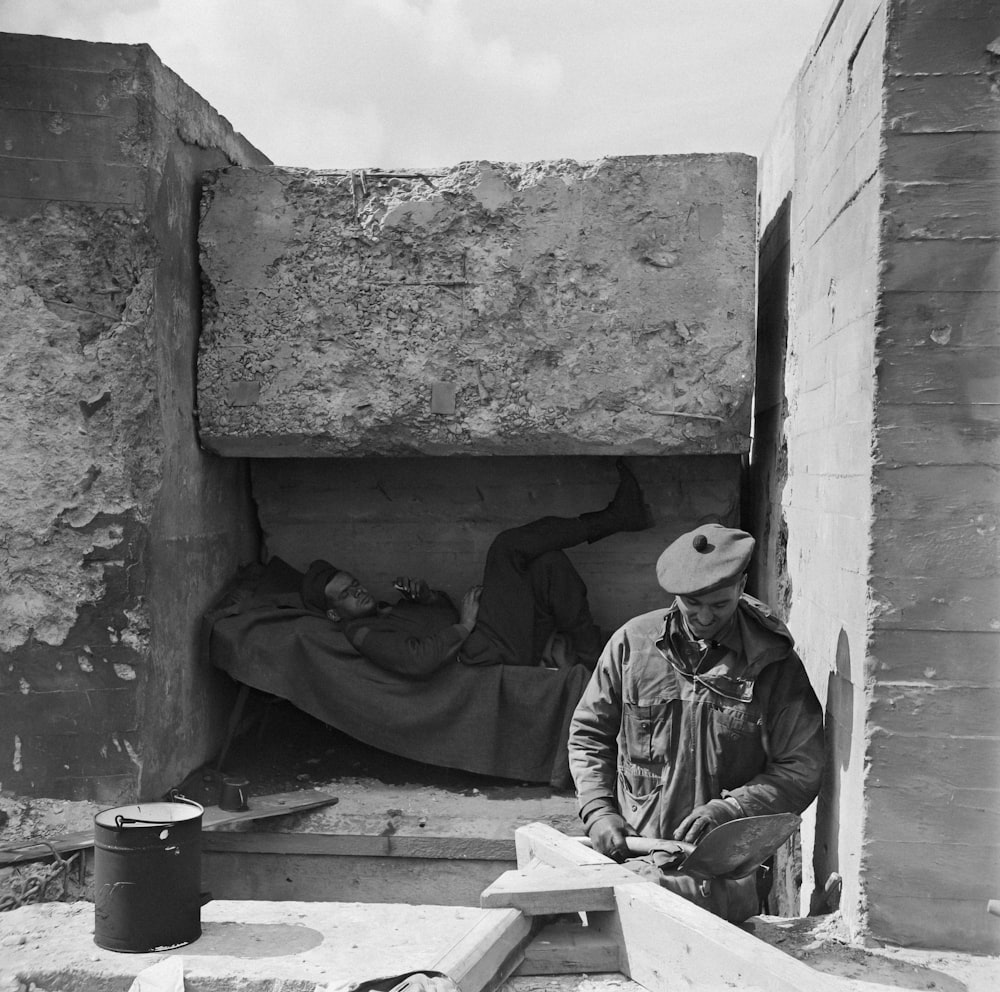 a man in a hat is sitting in a doorway