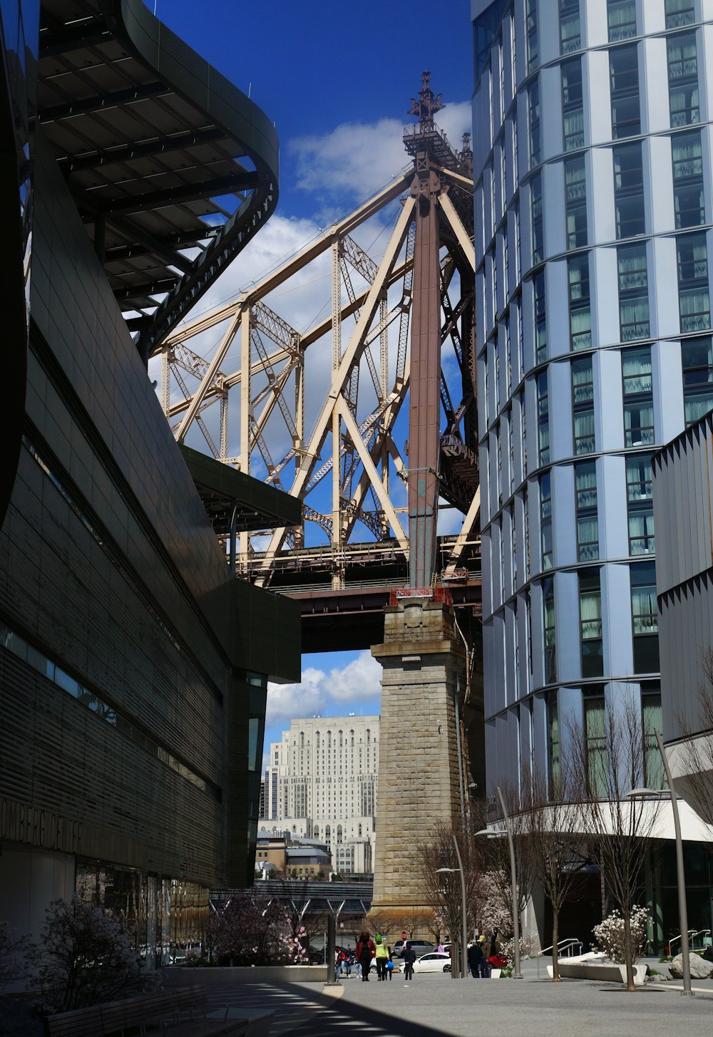 a tall bridge over a river next to a tall building