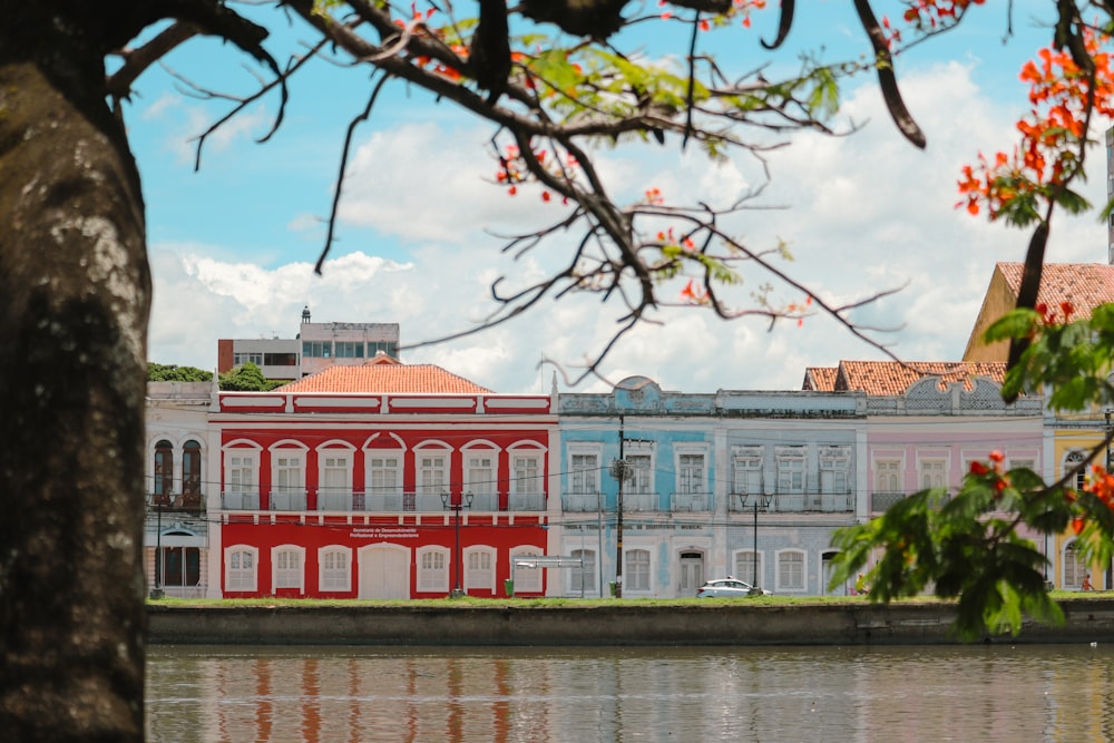 a red building sitting next to a body of water