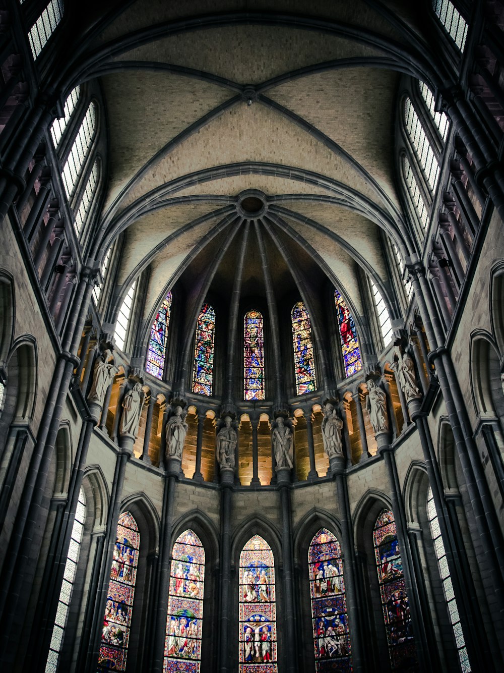 a large cathedral with stained glass windows and arches