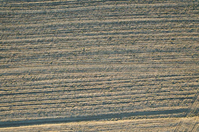 Close-up of a modern agricultural plow with soil texture