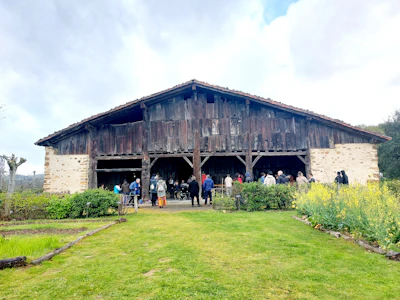 Community partners sharing smiles during a local food systems meeting in a rustic barn.