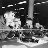 Guests sharing stories around a round table with headphones on.