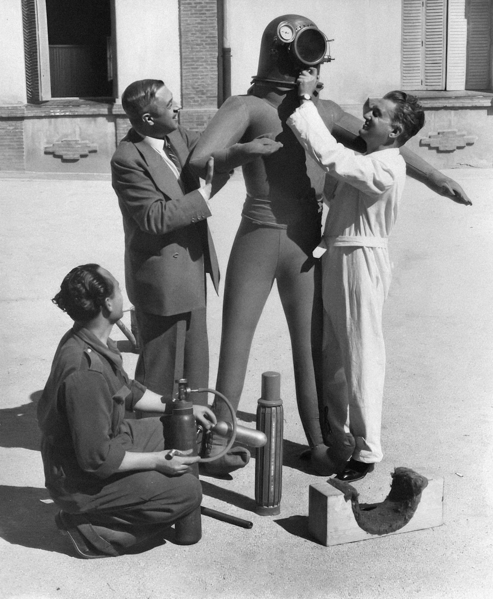 a group of people standing around a woman in a suit