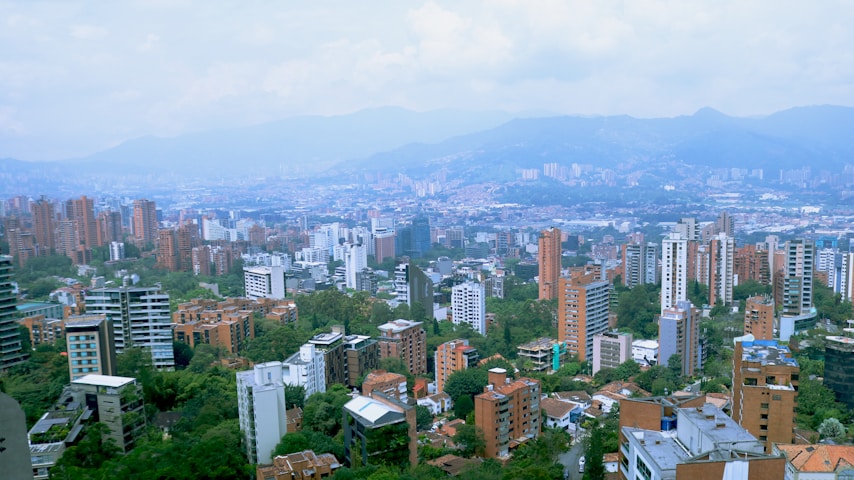 a view of a city with mountains in the background