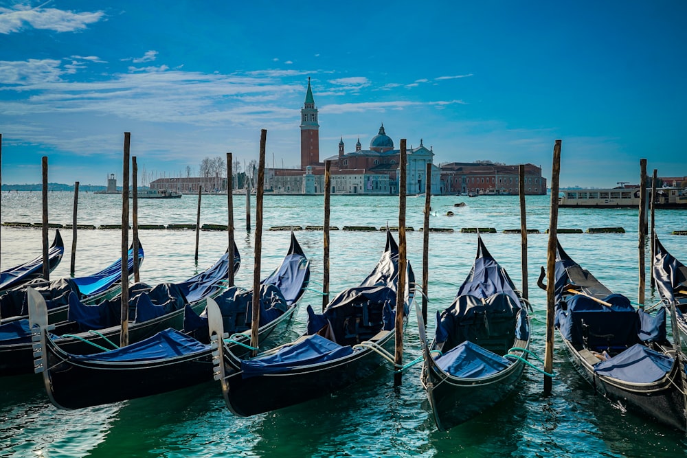 a bunch of gondolas that are sitting in the water