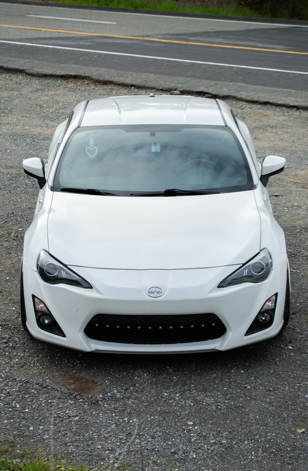 a white sports car parked on the side of the road