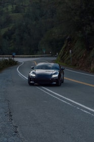 A scenic route in Kalimantan with a sleek travel car driving smoothly.