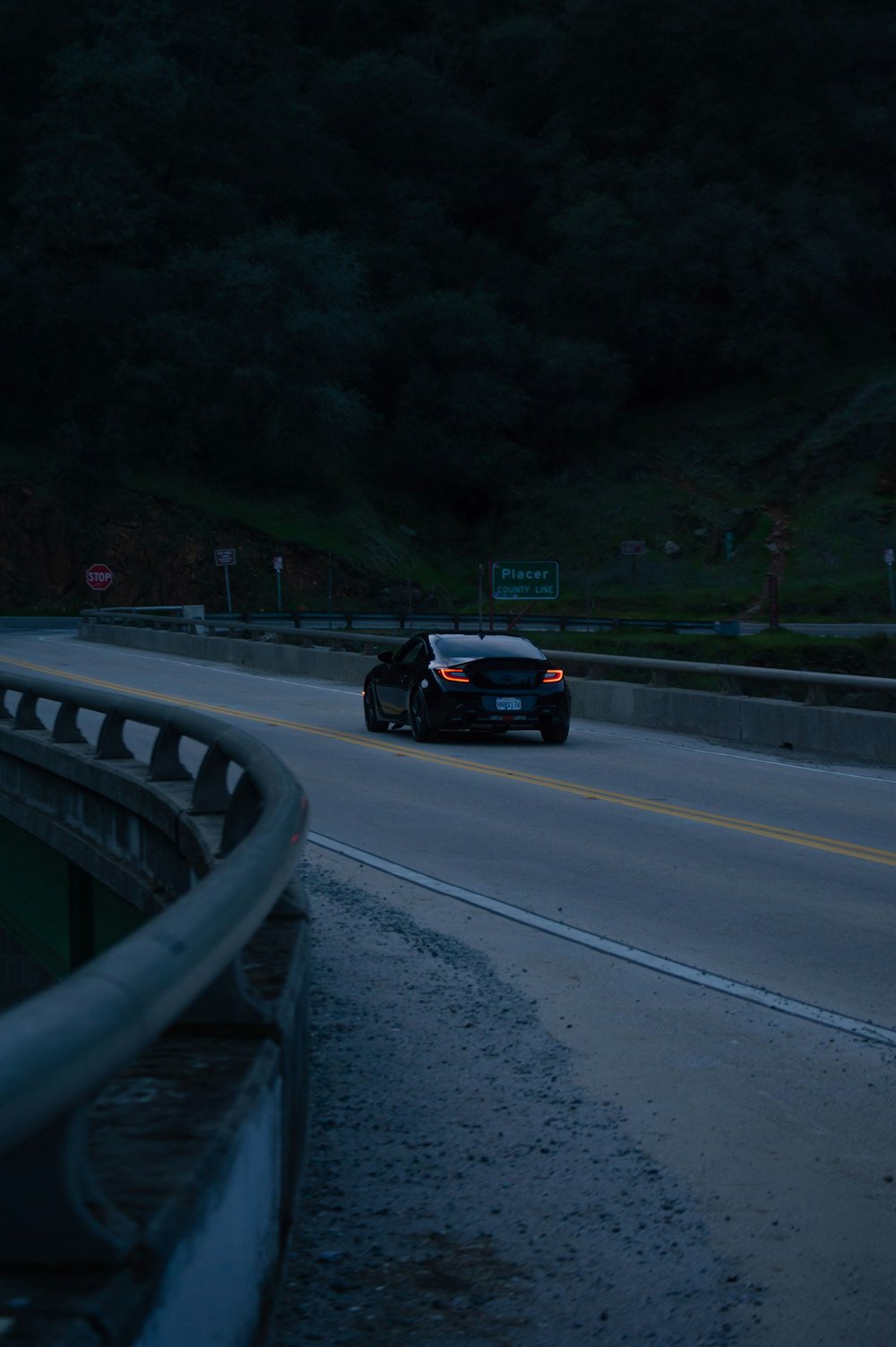 a police car driving down a highway at night