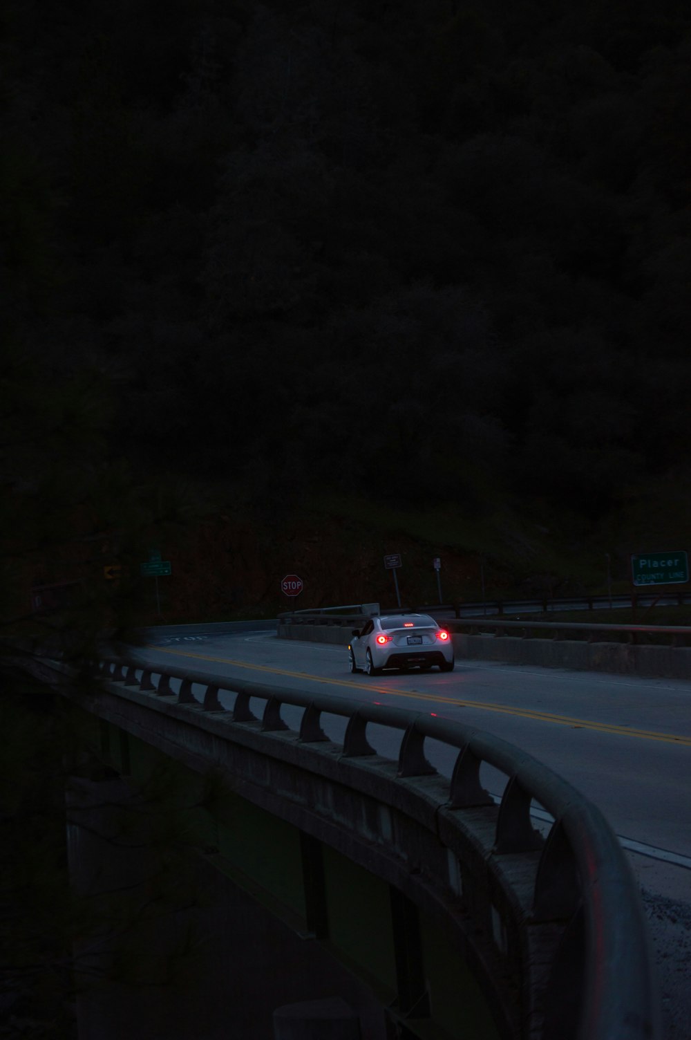 a car driving on a highway at night