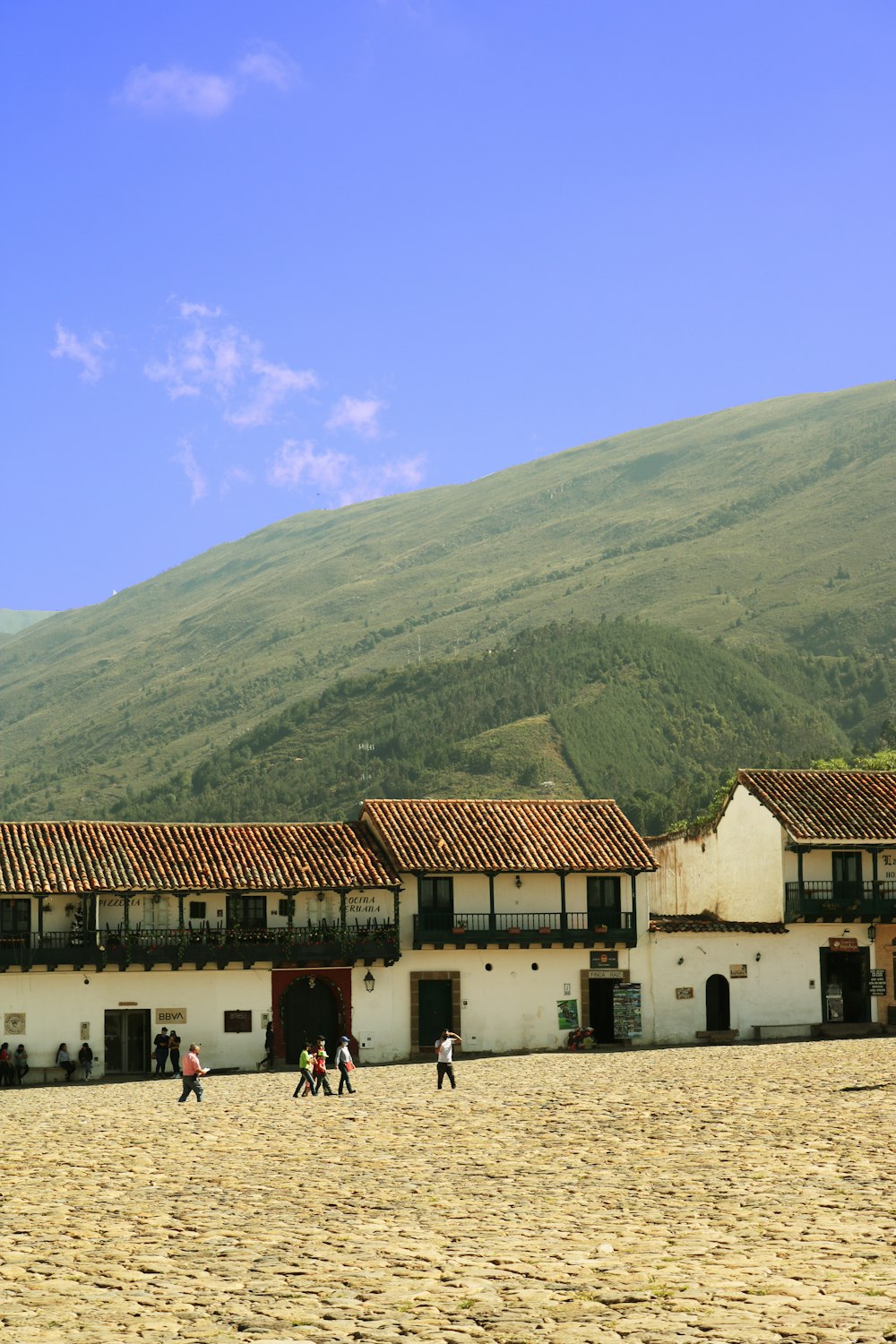 a group of people walking in front of a building