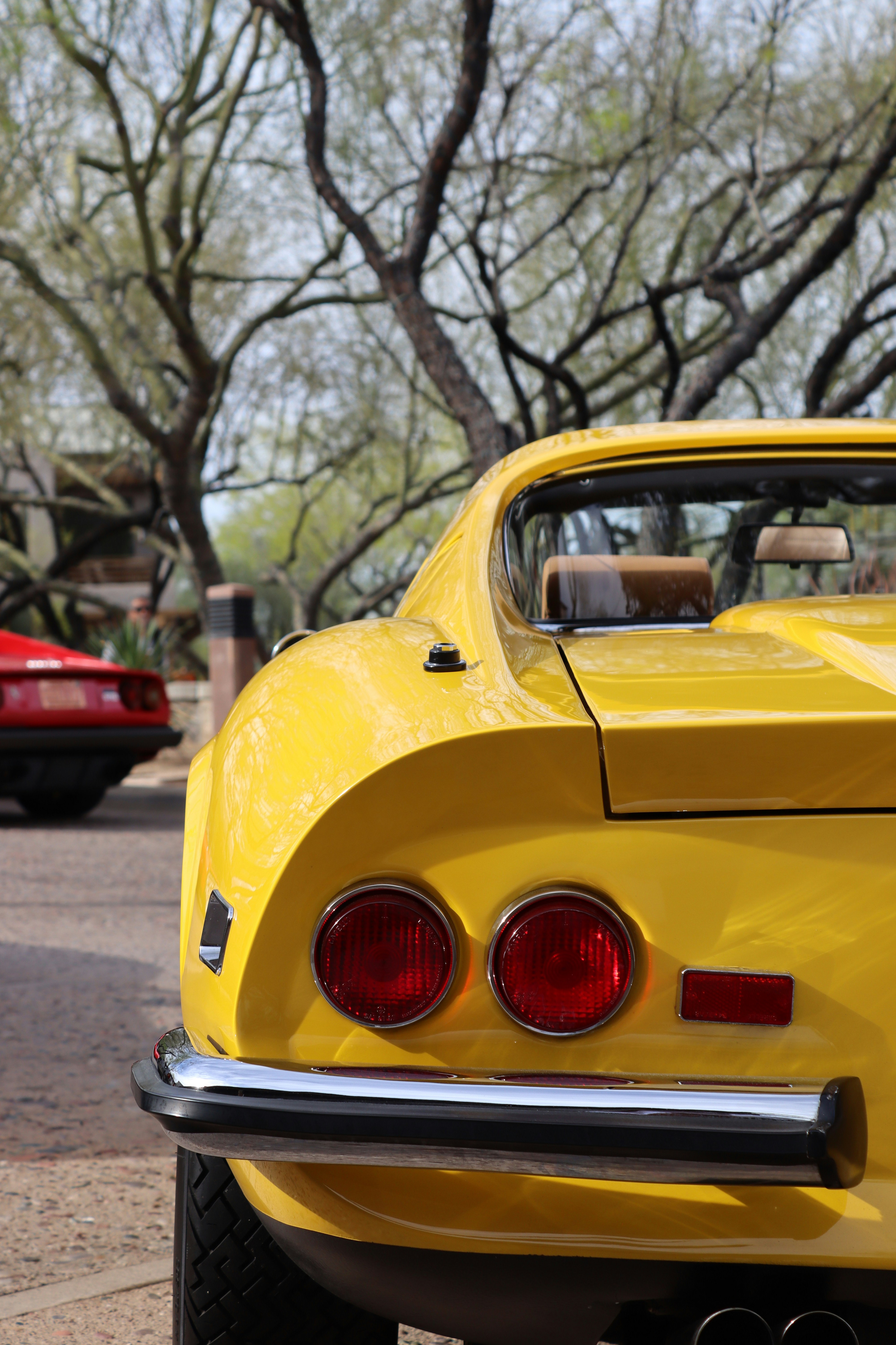 a yellow car parked on the side of the road