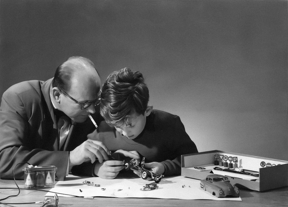 a man and a woman looking at a piece of paper